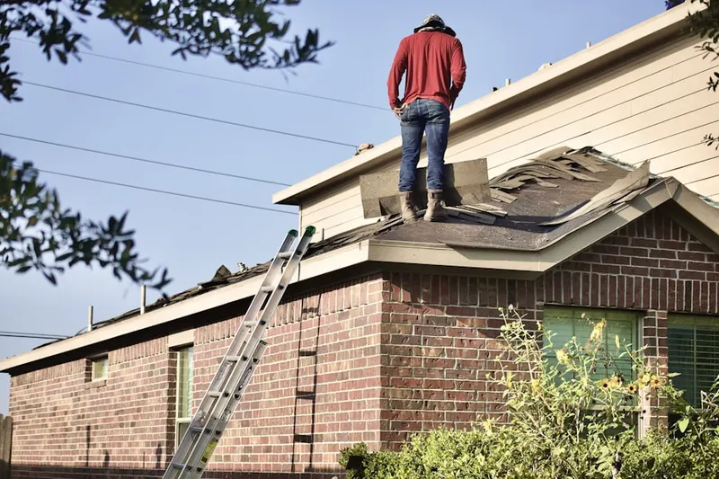 Professional roofer working on a residential roof in Lake Mohegan
